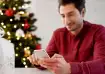 Man writing Christmas greeting message on phone