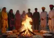Lohri bonfire ritual with peanuts, revri and popcorn offerings