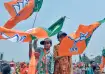 BJP supporters wave party flag/ File photo