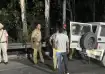 Punjab Police personnel conduct a search during a night