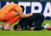 Uruguay goalkeeper Sergio Rochet comforts Uruguay's Mathias Olivera 