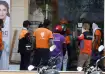 Swiggy workers waiting to collect orders in front of a