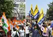 Congress and AAP workers wave party flags in separate