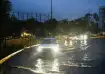 Vehicles wade ahead of the impending landfall of cyclonic