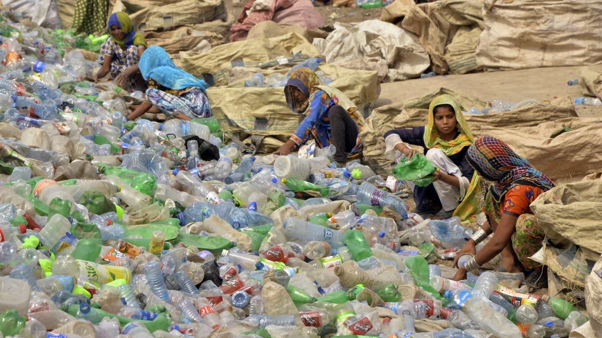 Pakistani woman collecting garbage.