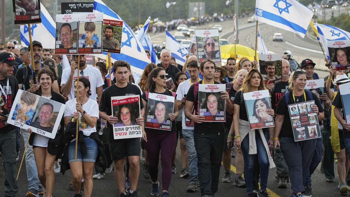 Israeli protestors carrying photographs of their loved members who are apprehended by Hamas militant