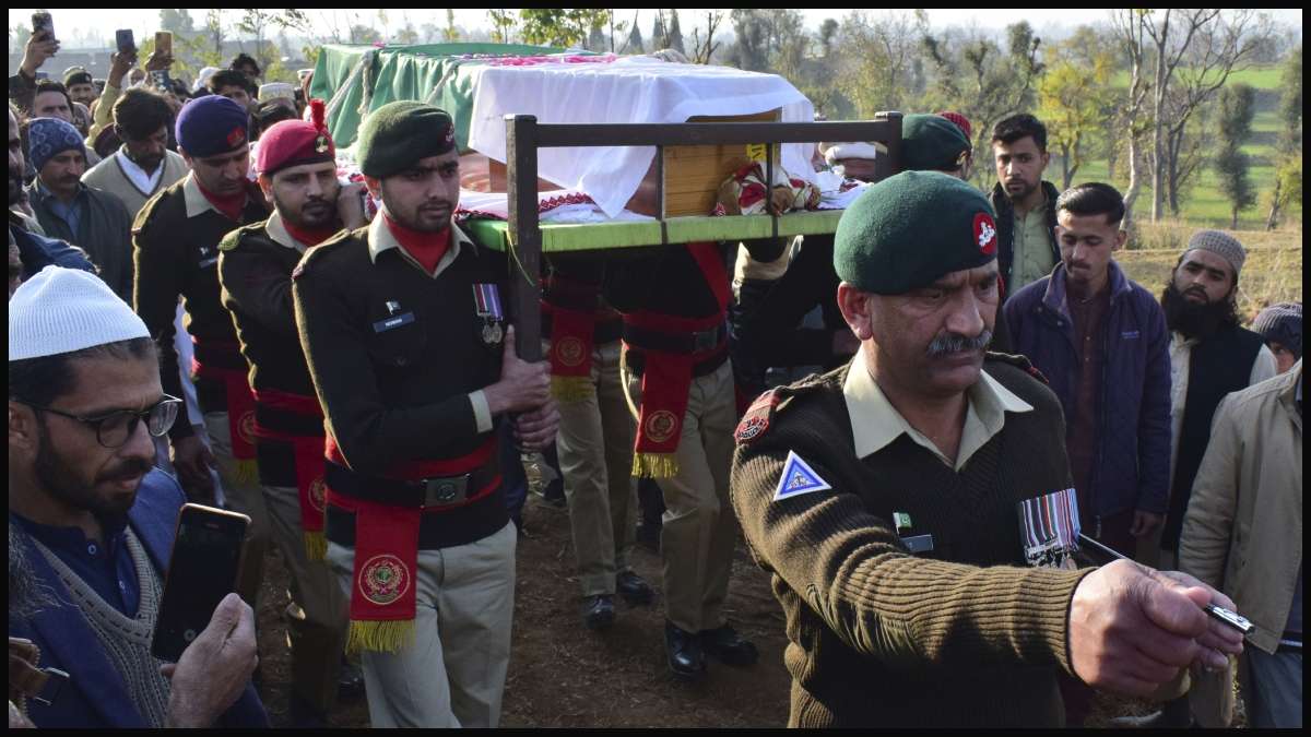 Villagers carry the casket of a soldier killed in Tuesday's