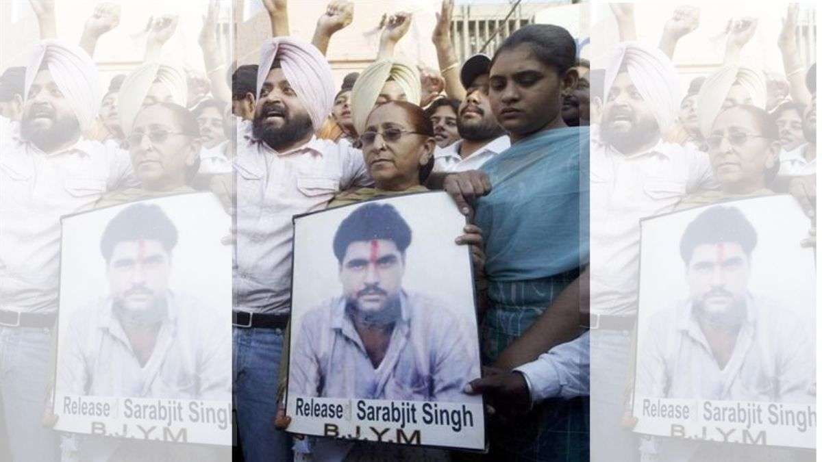 Family members of Sarabjit Singh hold his picture in Amritsar June 25 2009