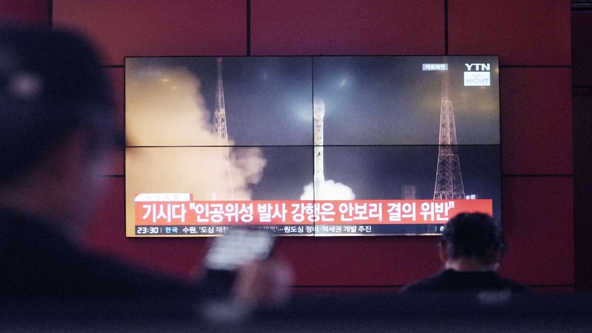 TV screen shows an image of North Korea's rocket launch in