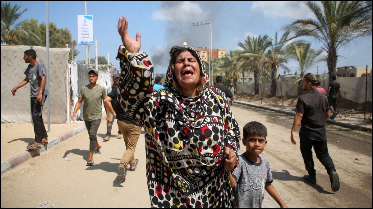 People react after an Israeli airstrike in Al-Mawasi, near