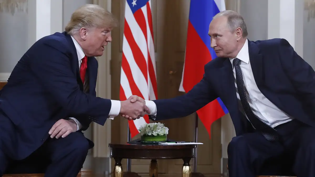 Russia's President Vladimir Putin shakes hands with then-US President Donald Trump during a meeting 