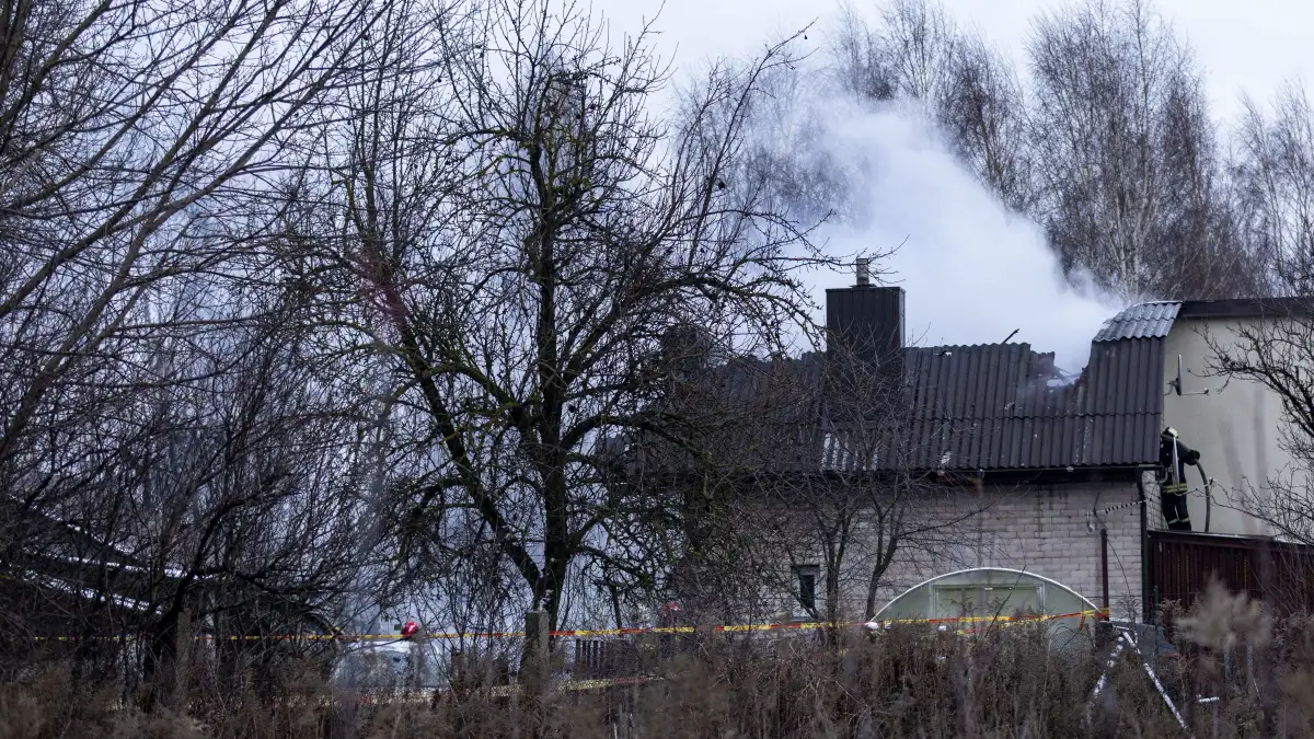 Smoke rises from the site where a DHL cargo plane crashed