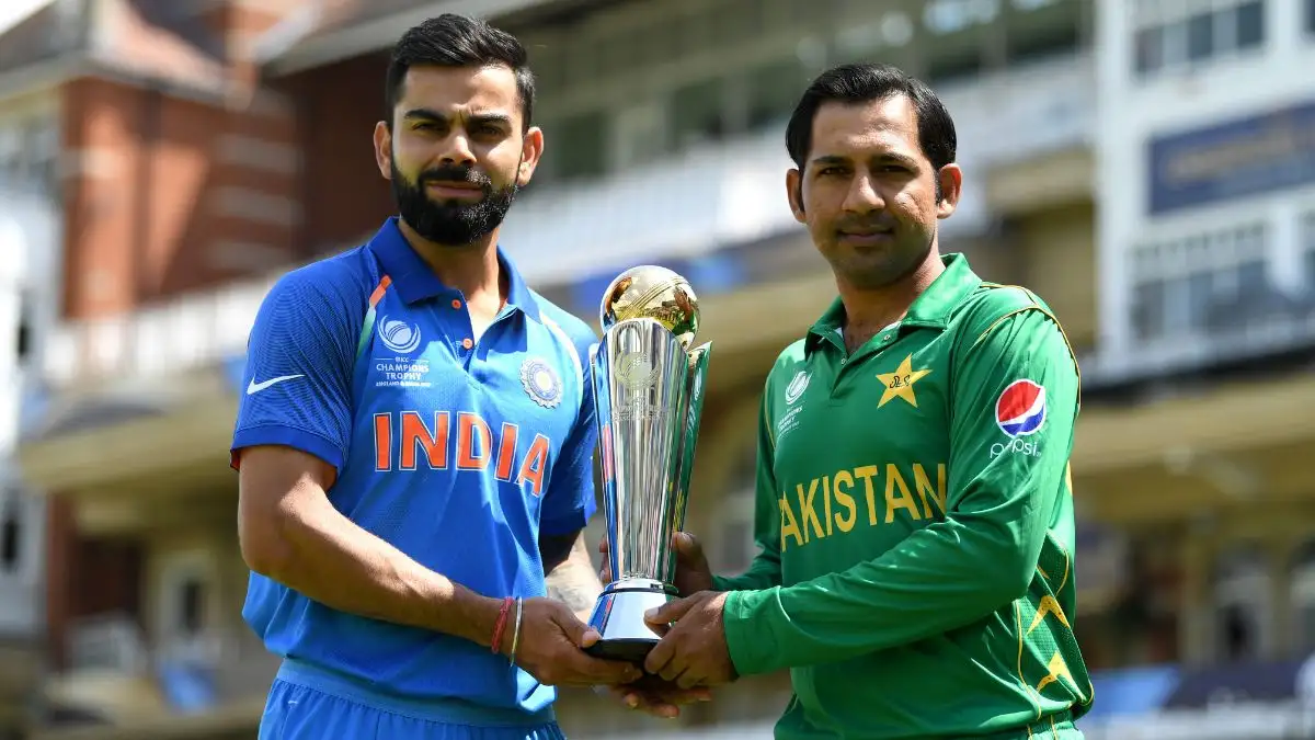 Virat Kohli and Sarfaraz Ahmed pose with the ICC Champions Trophy silverware.