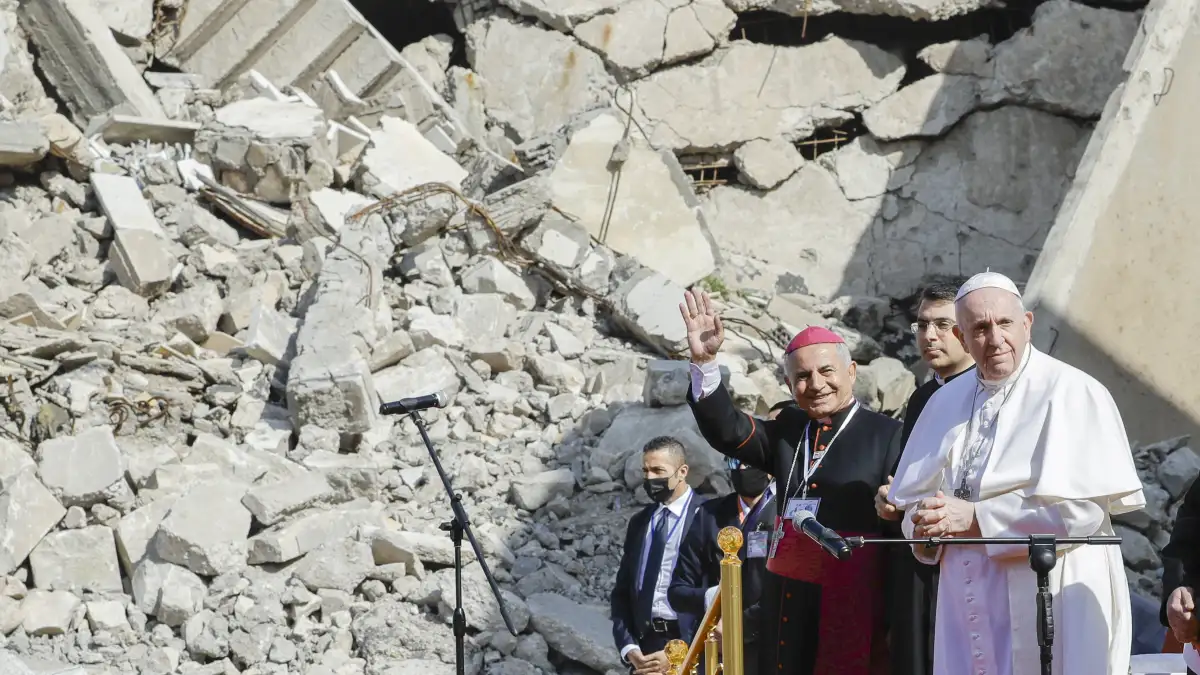 Mosul and Aqra Archbishop Najib Mikhael Moussa, left, waves as he stands next to Pope Francis at the