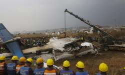 Nepalese rescuers and police are seen near the debris after