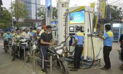 Petrol pump workers fill petrol in vehicles as fuel prices