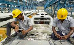Workers at the manufacturing facility of the Integral Coach