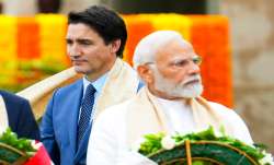 Canada's Prime Minister Justin Trudeau (left) walks past