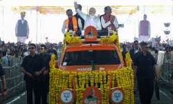 Prime Minister Narendra Modi waves at supporters as he