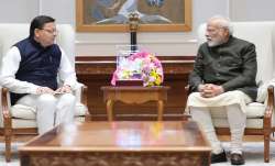 Uttarakhand CM Pushkar Dhami (left) with PM Modi (right).