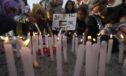 Palestinains light candle in response to Israel's attacks 