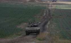 Israeli Defense Forces tank drives away from Gaza  Strip. 