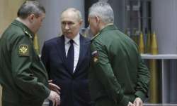 Russian President Vladimir Putin, (C), talks with Russian Chief of General Staff Gen. Valery Gerasim