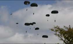 Parachutists jump from WWII-era planes into now peaceful