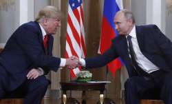 Russia's President Vladimir Putin shakes hands with then-US President Donald Trump during a meeting 