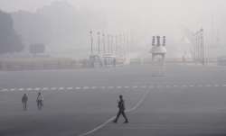 Pedestrian wearing on Kartavya Path as air quality