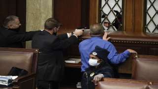 A mob invading the U.S. Capitol. Police officers with guns