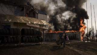 A man recovers items from a shop that caught fire from a