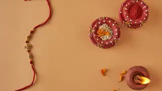 Decorative Rakhi with kumkum, rice, and diya
