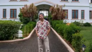 Jim Sarbh standing in front of his villa
