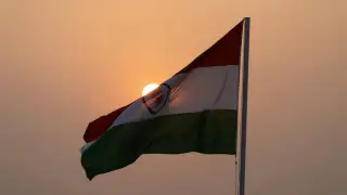 Indian national flag waving with the sun setting