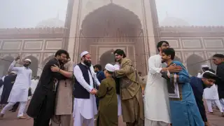 Members of the Muslim community exchange warm greetings on