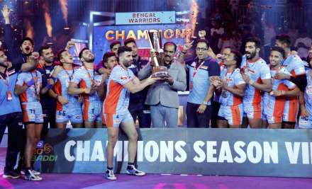 Players and officials of Bengal Warriors celebrate with the