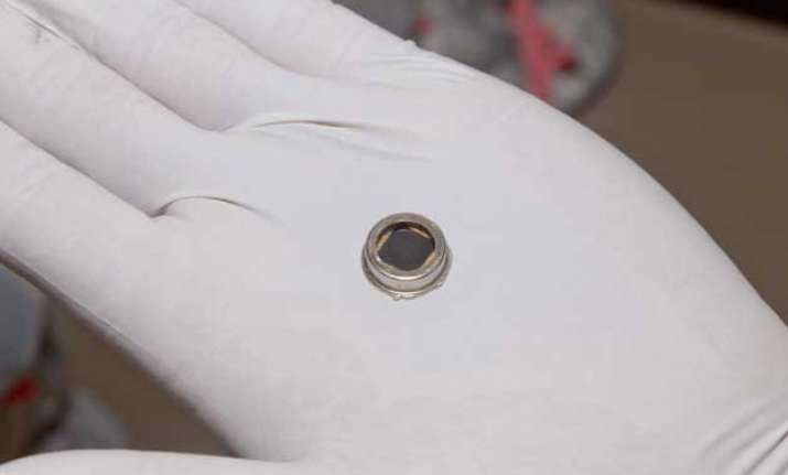 The dime-size microchip in this close-up image