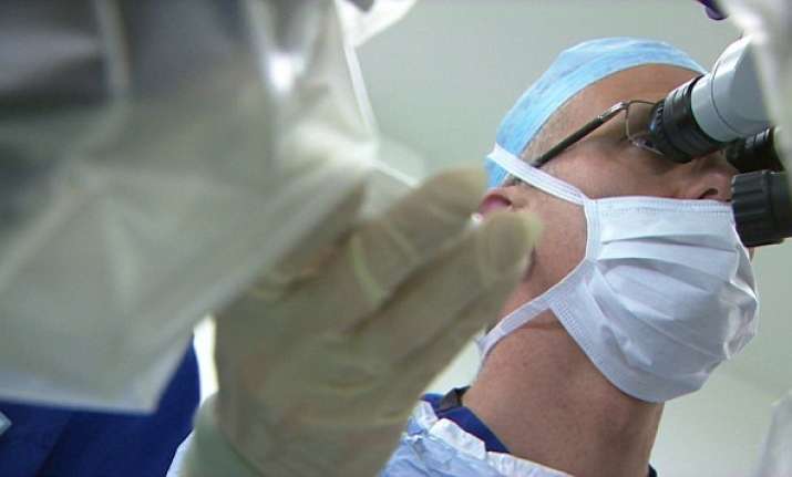 Professor MacLaren uses a joystick to control a needle
