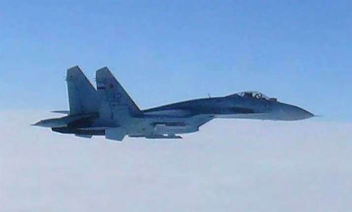 A Russian SU-27 fighter flies over the sea off the Japanese