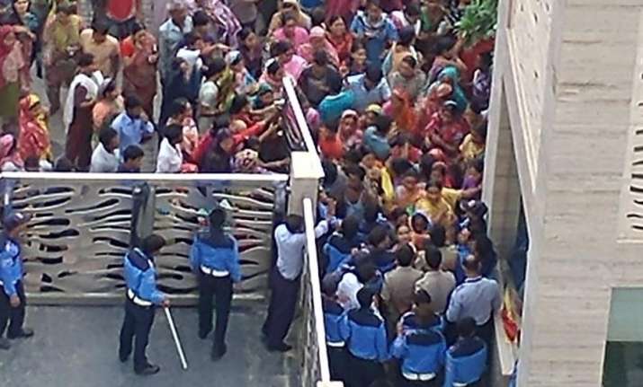 An angry mob pelted stones, breached the society gate and