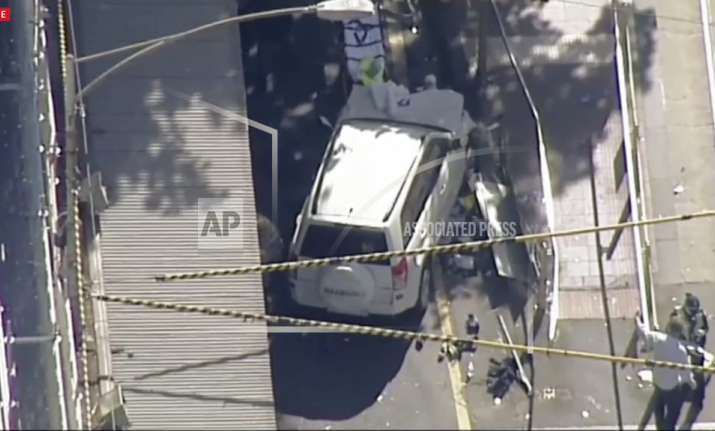 A white SUV vehicle is stopped after allegedly striking