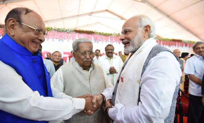 Vaghela was greeted by PM Modi at Rupani's swearing--in
