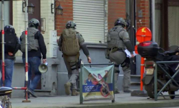 Belgium security personnel enter a building in Brussels in