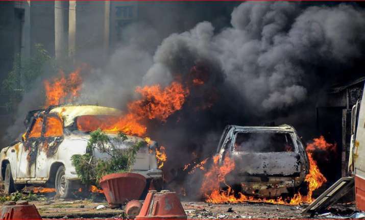 Smoke billows out of burning cars during 'Bharat Bandh'