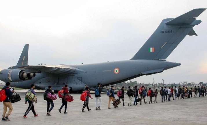Stranded Kashmir bound passengers queue up to board a C-17
