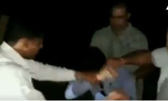 Stills from a video of the assault which is viral on social