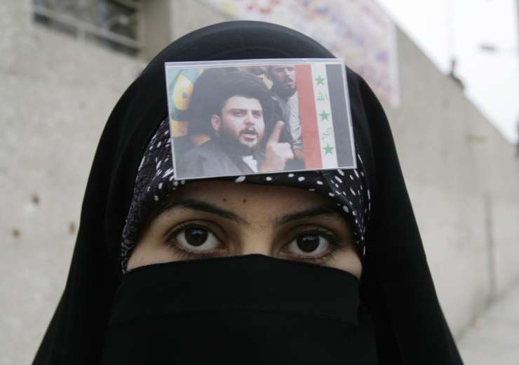  A Shiite woman, with a picture of radical cleric Muqtada al-Sadr on her veil, is seen during a protest in Sadr City, Baghdad, Iraq, Thursday, March 27, 2008.  - India Tv