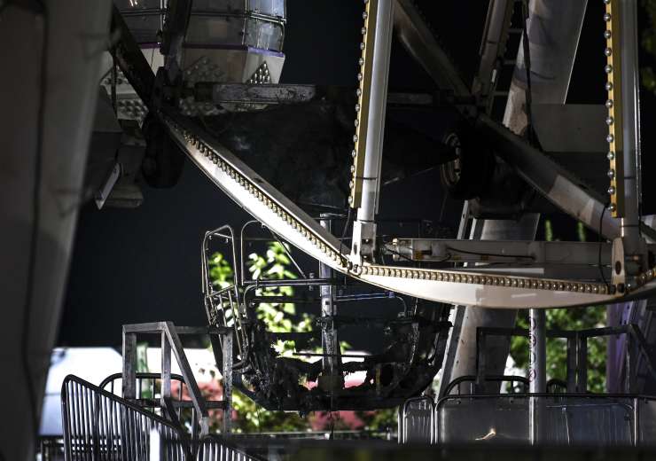 A burnt-out gondola of the Ferris wheel after a fire broke out in the Ferris wheel - India Tv