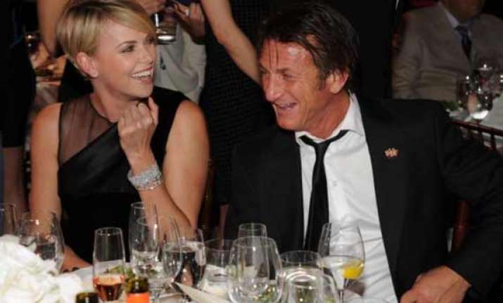 charlize theron sean penn to adopt a child
